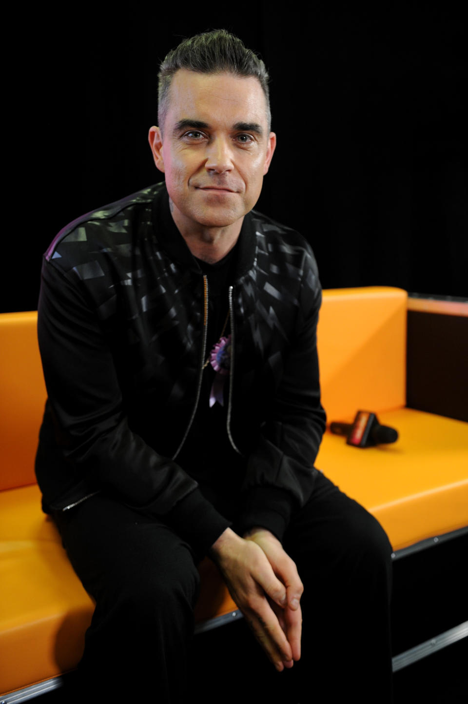 MANCHESTER, ENGLAND - DECEMBER 09:  Robbie Williams poses backstage at Key 103 Christmas Live at Manchester Arena on December 9, 2016 in Manchester, England.  (Photo by Shirlaine Forrest/Getty Images)