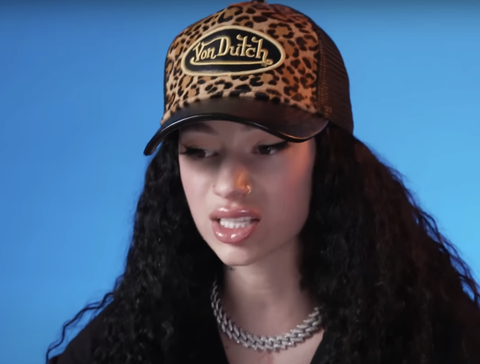 Bhad Bhabie wearing a leopard print cap and chain necklace