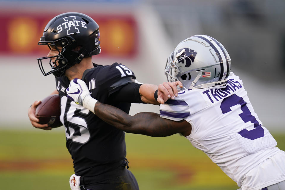 Iowa State quarterback Brock Purdy (15) breaks a tackle by Kansas State defensive back Kiondre Thomas (3) during the first half of an NCAA college football game, Saturday, Nov. 21, 2020, in Ames, Iowa. (AP Photo/Charlie Neibergall)