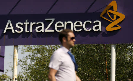 FILE PHOTO: A man walks past a sign at an AstraZeneca site in Macclesfield, central England May 19, 2014. REUTERS/Phil Noble//File Photo