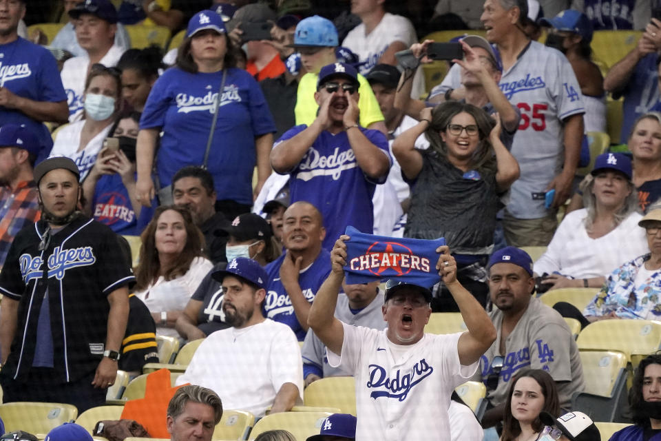 Fans boo as the Houston Astros take the field during the first inning of a baseball game against the Los Angeles Dodgers on Tuesday, Aug. 3, 2021, in Los Angeles. (AP Photo/Marcio Jose Sanchez)