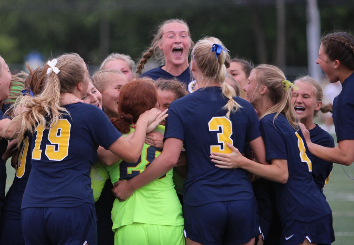 Hartland players celebrate a 2-1 victory over Grand Haven in a state Division 1 semifinal soccer game Tuesday, June 11, 2024 at Grand Ledge High School.