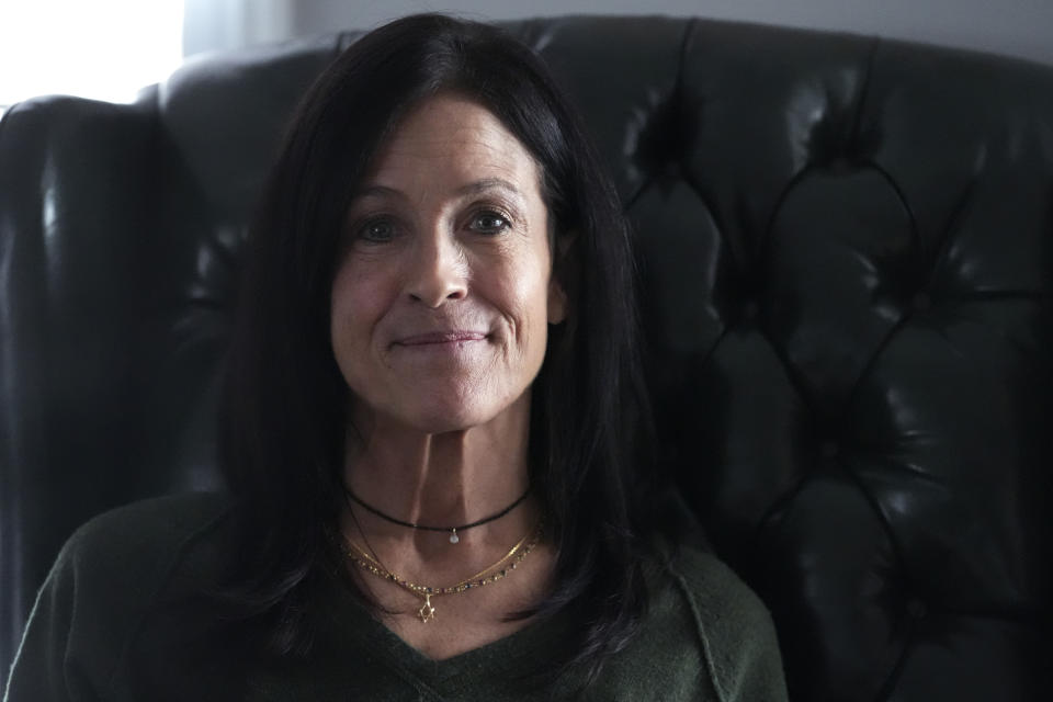 Jill Feldman, 54, poses for a photo at her home in Deerfield, Ill., Friday, Jan. 19, 2024. Lung cancer patient and advocate Jill Feldman takes pills at home that shrink tumors by blocking a signal that tells cancer cells to grow. (AP Photo/Nam Y. Huh)