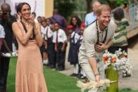 <p>KOLA SULAIMON/AFP via Getty</p> Meghan Markle and Prince Harry at Lightway Academy in Abuja, Nigeria on May 10, 2024.