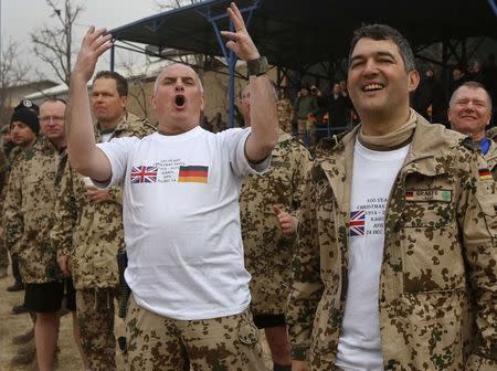German fans react during a football match between British and German troops commemorating the Christmas Truce of 1914, at the ISAF Headquarters in Kabul December 24, 2014. REUTERS/Omar Sobhani