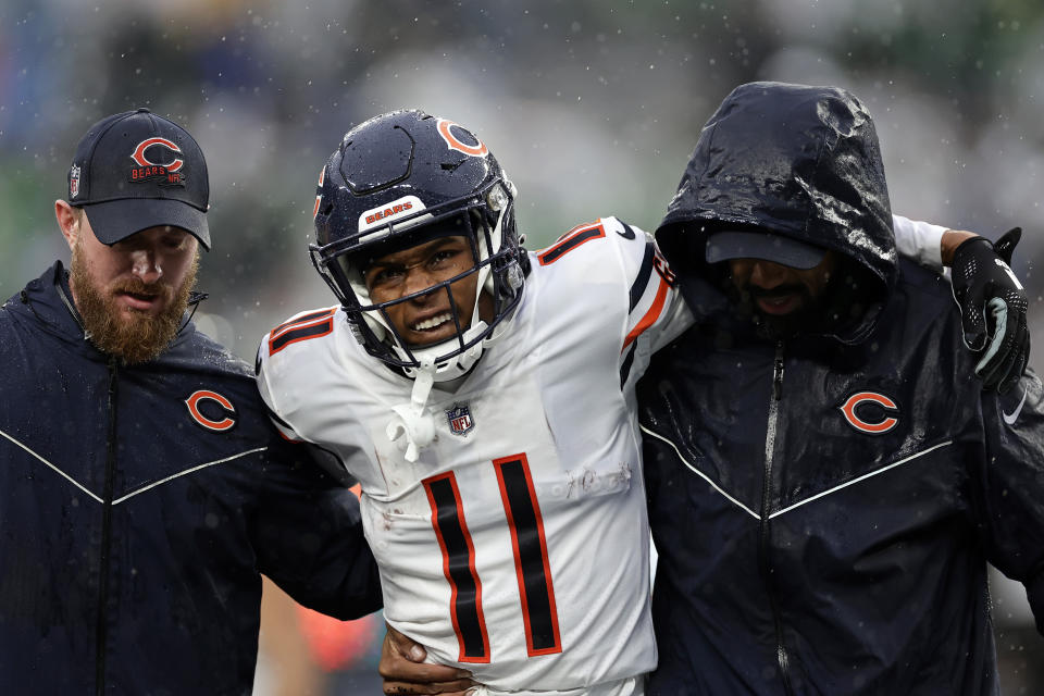 Chicago Bears wide receiver Darnell Mooney (11) is helped off the field against the New York Jets during an NFL football game Sunday, Nov. 27, 2022, in East Rutherford, N.J. (AP Photo/Adam Hunger)
