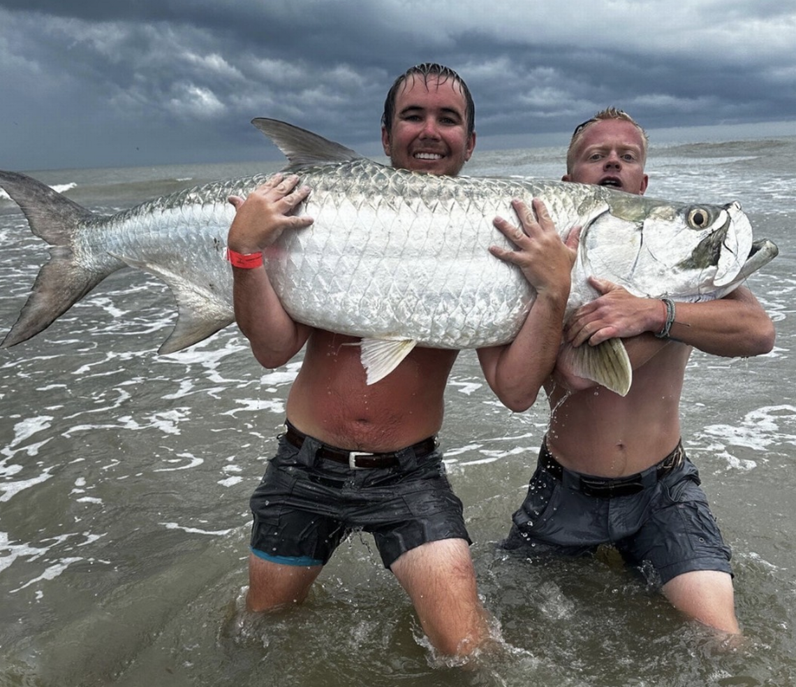 Phillip Sullivan, left, and James Strange reeled in a tarpon estimated at 150 pounds at Folly Beach.