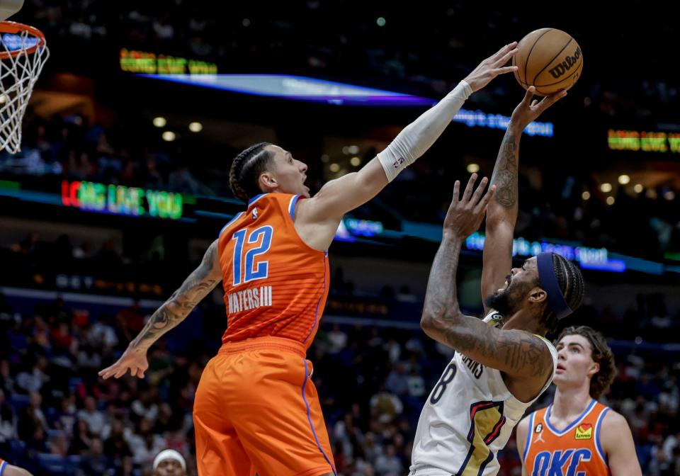 Oklahoma City Thunder forward Lindy Waters III (12) defends against New Orleans Pelicans forward Naji Marshall (8) during the second quarter of an NBA basketball game in New Orleans, Saturday, March 11, 2023. (AP Photo/Derick Hingle)