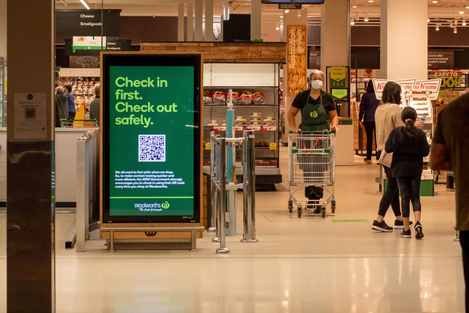 A check-in sign at the front of a Woolworths store. Source: Getty Images