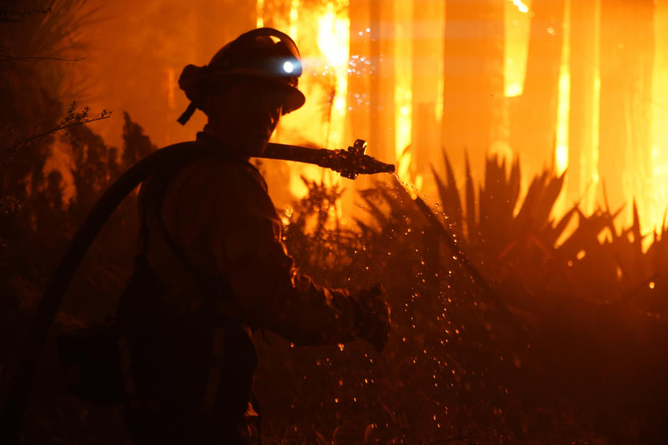 BOULDER CREEK, CA - August 22: Firefighters work to protect homes surrounding residences engulfed in flames on Madrone Ave at the corner of Virginia Ave before 2 a.m. in Boulder Creek, Calif., on Friday, August 22, 2020. (Photo by Dylan Bouscher/MediaNews Group/The Mercury News via Getty Images)