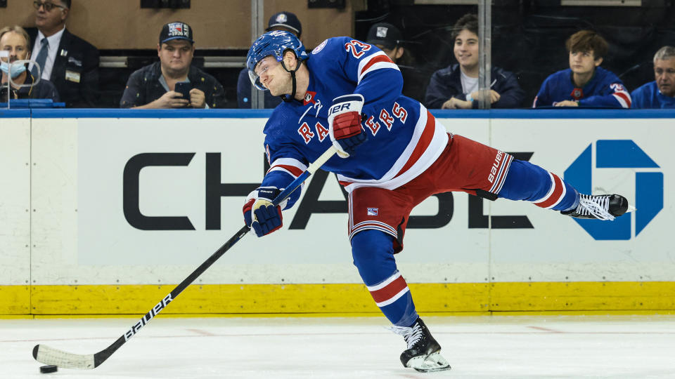 Oct 14, 2021; New York, New York, USA; New York Rangers defenseman Adam Fox (23) shoots the puck up ice against the Dallas Stars during the second period at Madison Square Garden.