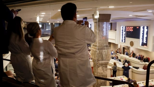 Doctors from the Alabama Fertility Clinic take photos of votes