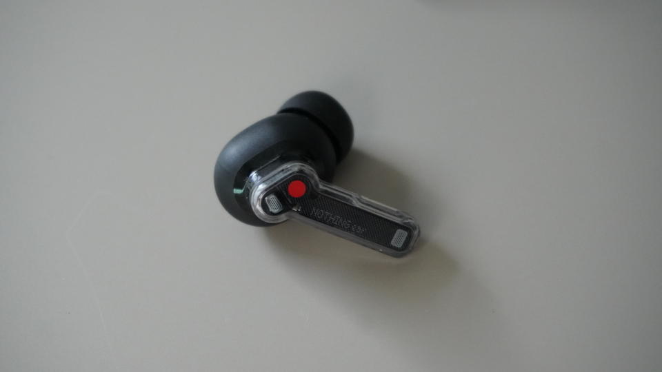 The Nothing Ear wireless earbuds in black on a grey background