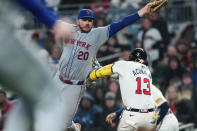 Atlanta Braves' Ronald Acuña Jr. (13) avoids the tag from New York Mets first base Pete Alonso (20) for a base hit in the sixth inning of a baseball game Tuesday, April 9, 2024, in Atlanta. (AP Photo/John Bazemore)