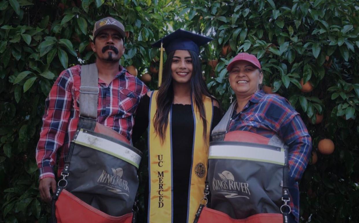 Anna Ocegueda, who will graduate from college on Sunday, poses with her migrant parents. (Photo: Twitter)