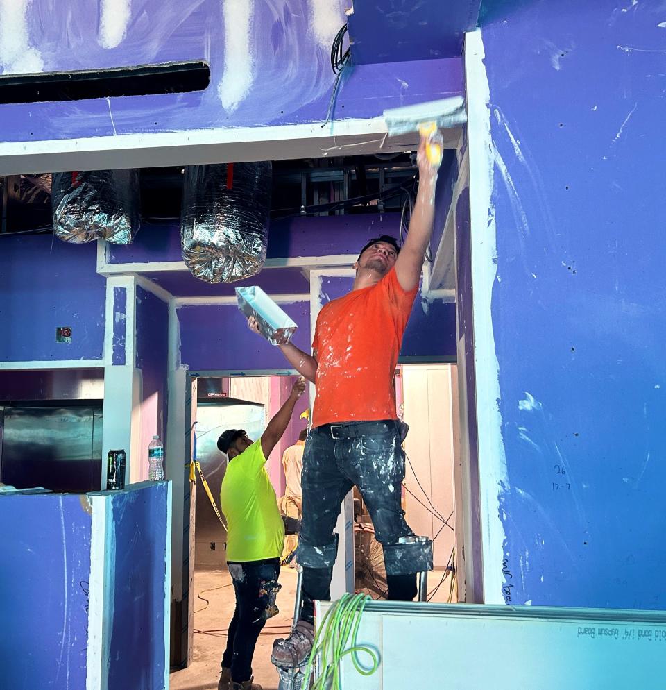 Workers get Cape Coral's new Mellow Mushroom restaurant ready for its planned June 3 grand opening.