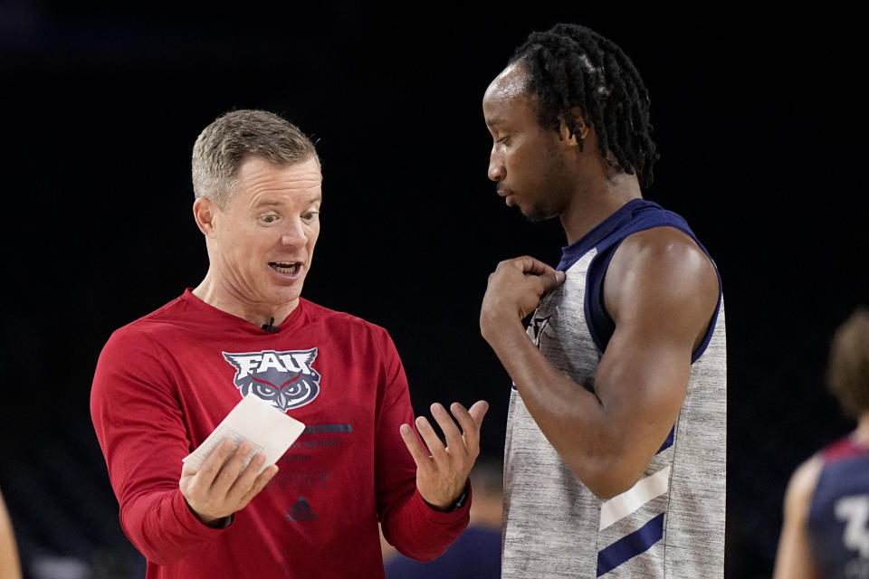 Florida Atlantic head coach Dusty May talks with guard Michael Forrest during practice for their Final Four college basketball game in the NCAA Tournament on Friday, March 31, 2023, in Houston. San Diego State and Florida Atlantic play on Saturday. (AP Photo/Brynn Anderson)