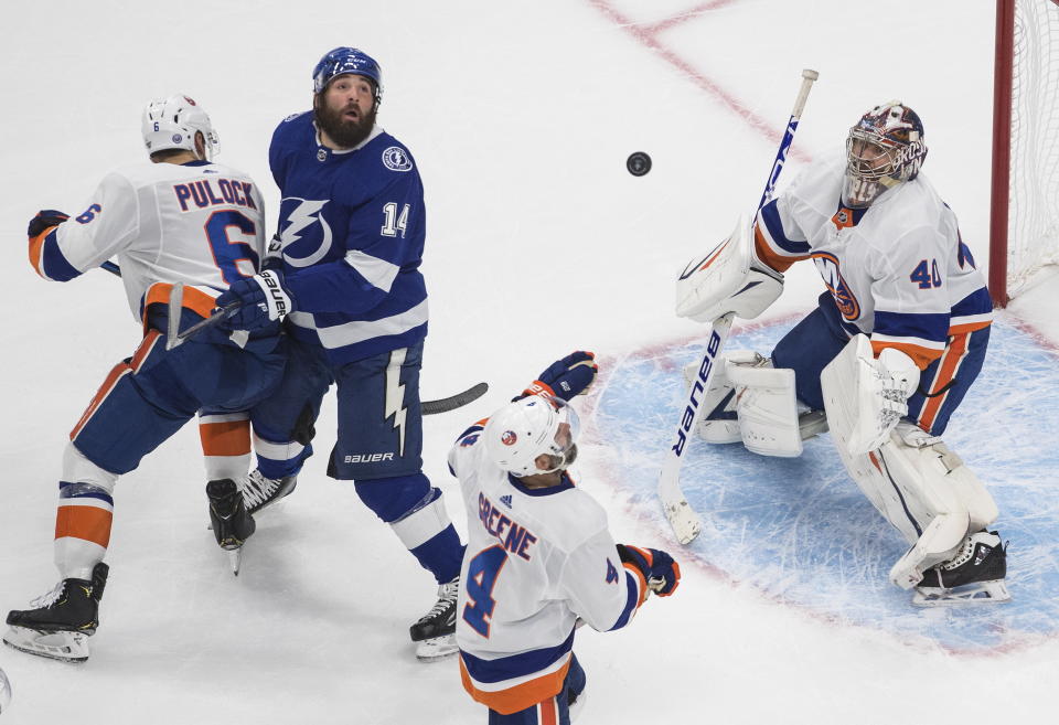 Tampa Bay Lightning's Pat Maroon (14) and New York Islanders' Andy Greene (4) look for the rebound from Islanders goalie Semyon Varlamov (40) as Islanders' Ryan Pulock (6) defends during second-period NHL Eastern Conference final playoff game action in Edmonton, Alberta, Monday, Sept. 7, 2020. (Jason Franson/The Canadian Press via AP)