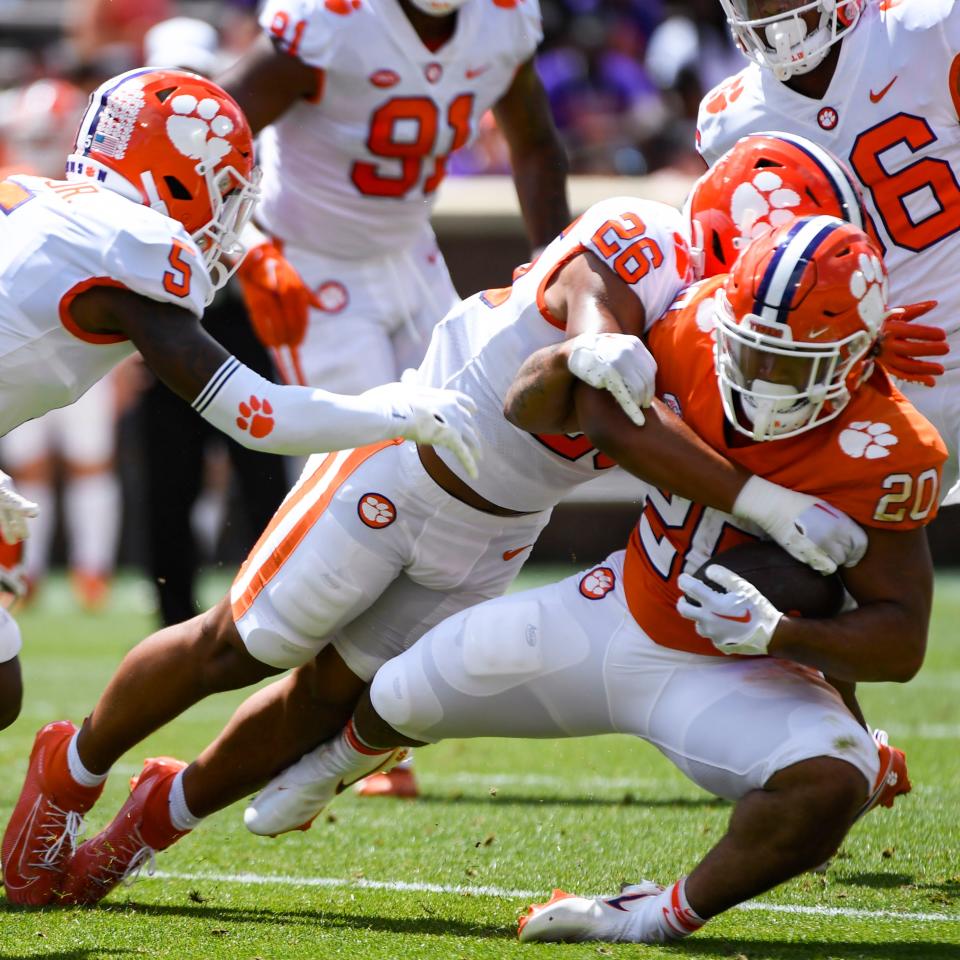 Clemson linebacker T.J. Dudley (26) tackles Clemson running back Domonique Thomas (20) during the annual Orange and White Spring game at Memorial Stadium in Clemson, S.C. Saturday, April 15, 2023. 