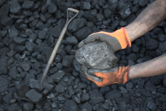 Large chunk of coal in the hands of a miner