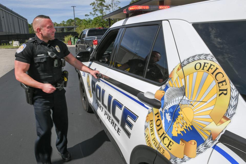 Fort Pierce Police Officer Chris Davis returns to his police SUV to check a driver's license during a traffic stop along Okeechobee Road on Wednesday Sept. 6, 2023, in Fort Pierce. Police have been stepping up traffic enforcement along Okeechobee Road where traffic is increasing because of a growing population and business growth in the area.