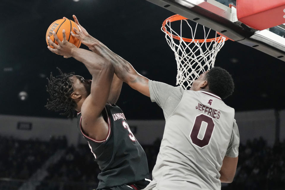 Mississippi State forward D.J. Jeffries (0) fouls South Carolina forward Josh Gray (33) during the first half of an NCAA college basketball game, Saturday, March 9, 2024, in Starkville, Miss. South Carolina wins in overtime 93-89. (AP Photo/Rogelio V. Solis)