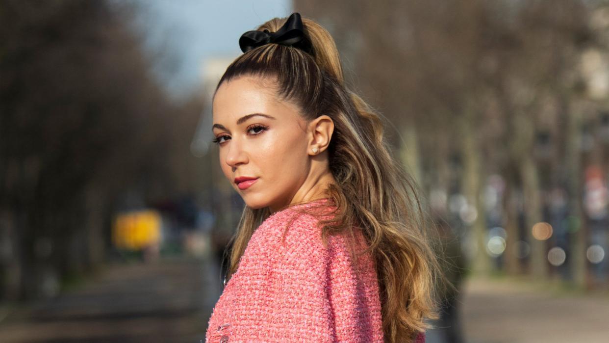 Portrait of Digital influencer Lyna Zerrouki wearing a Chanel suit in Paris, France