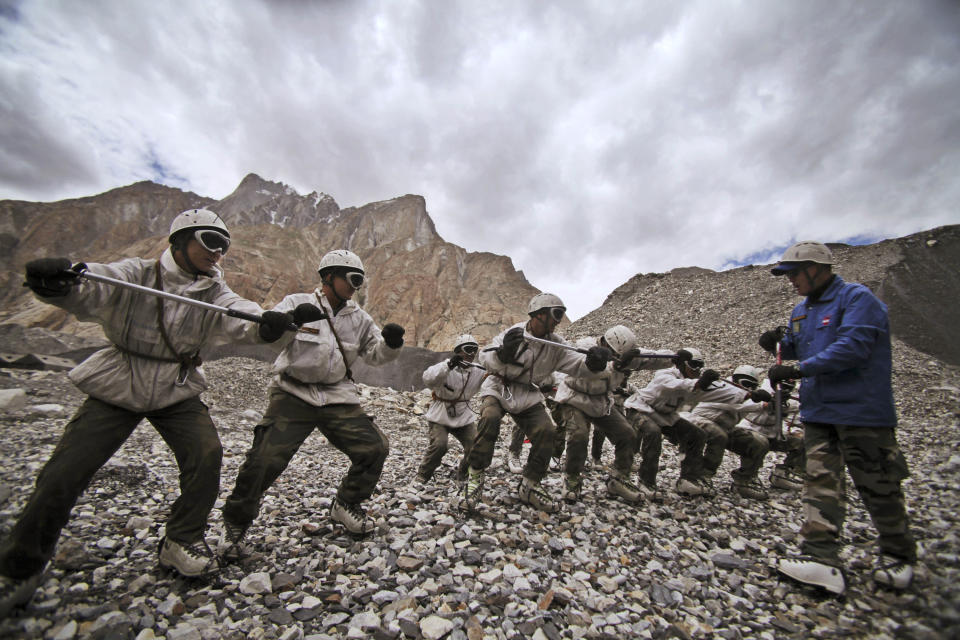 FILE- Indian army soldiers undergo a training session at the Siachen base camp, in Indian Kashmir on the border with Pakistan, July 19, 2011. The remains of an Indian army soldier have been found more than 38 years after he went missing on a glacier at the highest point along the heavily militarized disputed border between India and Pakistan in Kashmir, officials said Wednesday. (AP Photo/Channi Anand, File)