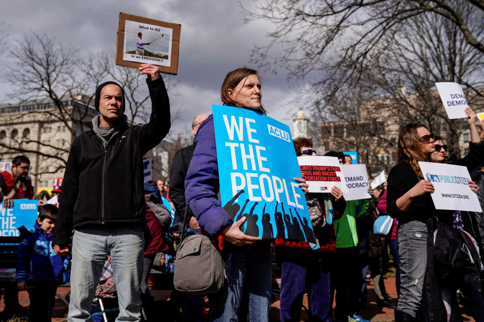 People hold signs during a demonstration against U.S. President Donald Trump on President's day near the White House in Washington,  Feb. 18, 2019.  (Photo: Joshua Roberts/Reuters)