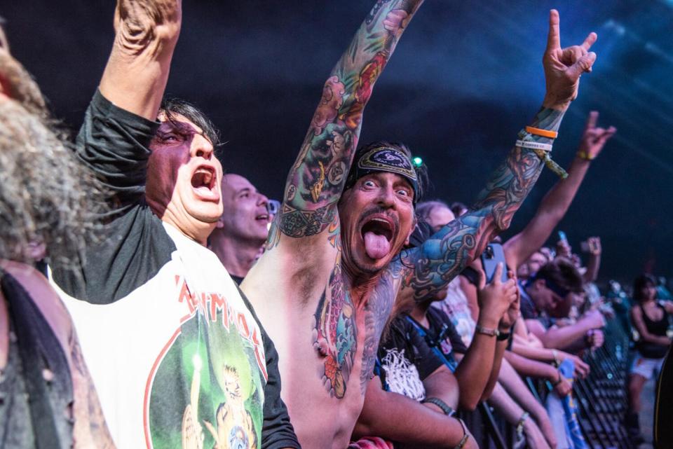 A shirtless fan with his tongue out looks at the camera at Power Trip.