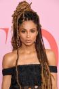 <p>Some of Ciara's gorgeous ombré brunette locs are gathered at the top of her head in a top knot while the rest cascades long past her shoulders.</p>