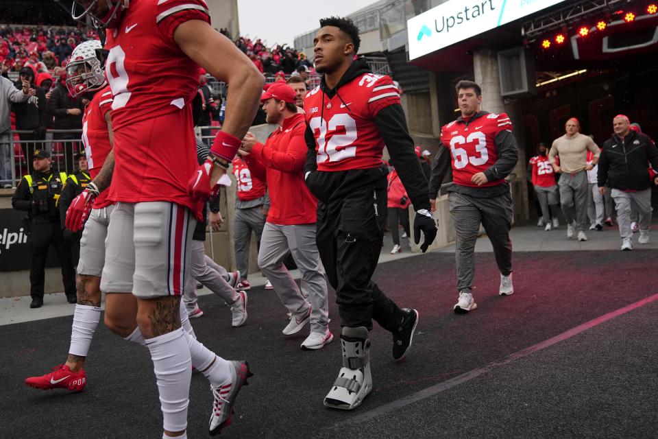 Nov 12, 2022; Columbus, Ohio, USA; Ohio State Buckeyes running back TreVeyon Henderson walks onto the field in a boot prior to the NCAA football game against the Indiana Hoosiers at Ohio Stadium. Mandatory Credit: Adam Cairns-The Columbus Dispatch