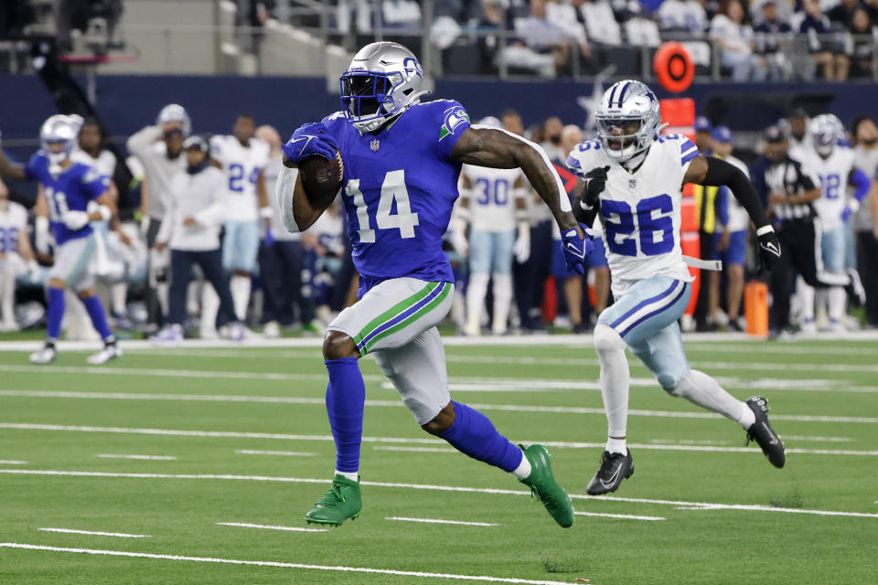 Seattle Seahawks wide receiver DK Metcalf (14) sprints to the end zone to score a touchdown after making a catch as Dallas Cowboys cornerback DaRon Bland (26) gives chase in the first half of an NFL football game in Arlington, Texas, Thursday, Nov. 30, 2023. (AP Photo/Michael Ainsworth)