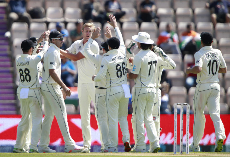 New Zealand's Kyle Jamieson, fourth left, center without cap, celebrates with teammates the dismissal of India's captain Virat Kohli during the sixth day of the World Test Championship final cricket match between New Zealand and India, at the Rose Bowl in Southampton, England, Wednesday, June 23, 2021. (AP Photo/Ian Walton)