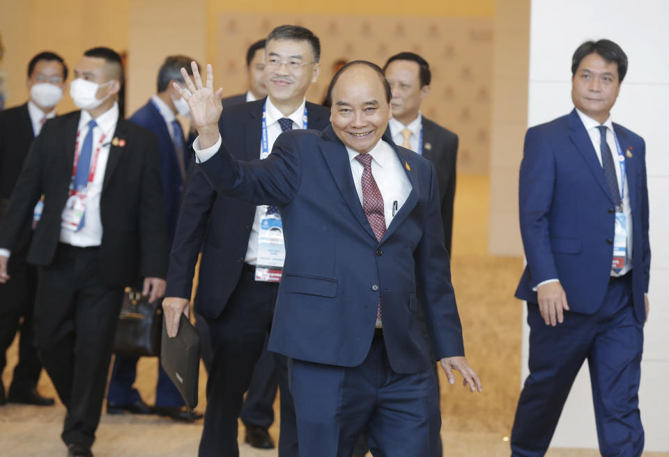Vietnam's President Nguyen Xuan Phuc, center, waves as he arrives to attend the APEC Economic Leaders' Meeting during the APEC summit, Friday, Nov. 18, 2022, in Bangkok, Thailand. (Diego Azubel/Pool Photo via AP)