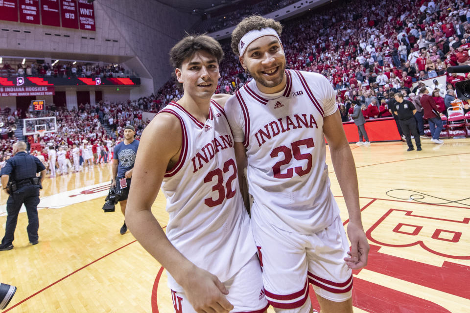 Indiana guard Trey Galloway (32) and forward Race Thompson (25) react after defeating Michigan in overtime of an NCAA college basketball game, Sunday, March 5, 2023, in Bloomington, Ind. (AP Photo/Doug McSchooler)