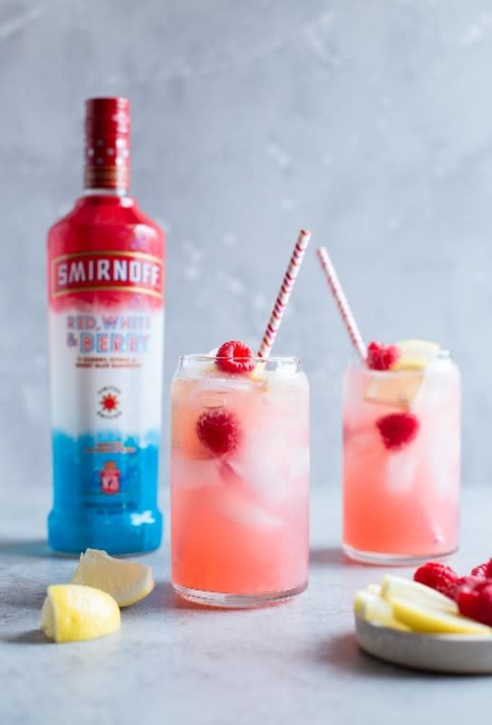 <p>Smirnoff</p><p>Red, white and berry drinks should always be on the menu on the 4th of July. This mix of cherry, citrus and blue raspberry flavors blend perfectly into any cocktail.</p><p>Recipe Courtesy of <a href="https://www.smirnoff.com/en-us/" rel="nofollow noopener" target="_blank" data-ylk="slk:Smirnoff;elm:context_link;itc:0;sec:content-canvas" class="link rapid-noclick-resp">Smirnoff</a>:</p><p>• 1.5 ounces Smirnoff Red, White and Berry </p><p>• 4 oz raspberry lemonade </p><p>• 2 oz lemon-lime soda </p><p>• lemon wedges and fresh raspberries for garnish</p><p><strong>Related: <a href="https://parade.com/1057348/pipandebby/best-canned-cocktails/" rel="nofollow noopener" target="_blank" data-ylk="slk:27 Canned Cocktails to Try;elm:context_link;itc:0;sec:content-canvas" class="link rapid-noclick-resp"> 27 Canned Cocktails to Try</a></strong></p>
