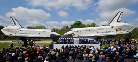 Space shuttles Enterprise, left, and Discovery meet nose-to-nose at the beginning of a transfer ceremony at the Smithsonian's Steven F. Udvar-Hazy Center, Thursday, April 19, 2012, in Chantilly, Virginia.