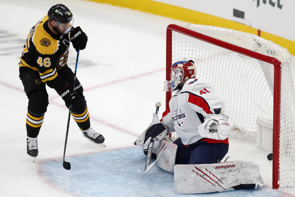 Boston Bruins' David Krejci (46) scores on Washington Capitals' Vitek Vanecek (41) during the first period of an NHL hockey game, Sunday, April 18, 2021, in Boston. (AP Photo/Michael Dwyer)