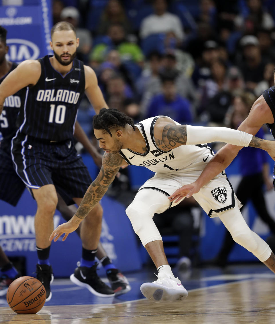 Brooklyn Nets' D'Angelo Russell, right, goes after a loose ball in front of Orlando Magic's Evan Fournier (10) during the first half of an NBA basketball game, Friday, Jan. 18, 2019, in Orlando, Fla. (AP Photo/John Raoux)