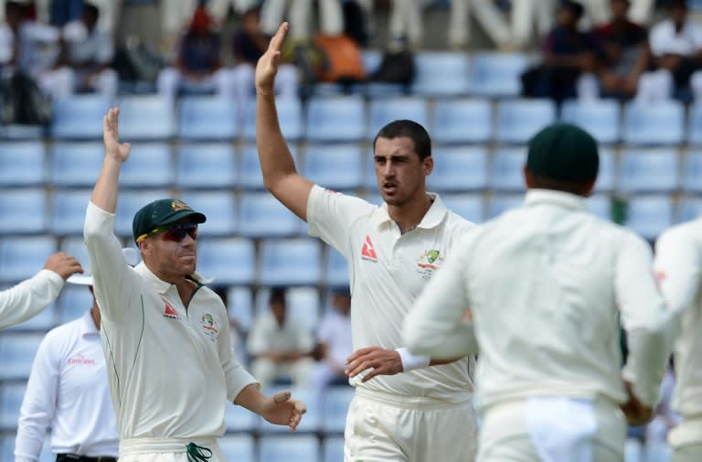 Australia's Mitchell Starc (centre) celebrates after dismissing Sri Lanka's Dimuth Karunaratne on the first day of the opening Test in Pallekele on July 26, 2016