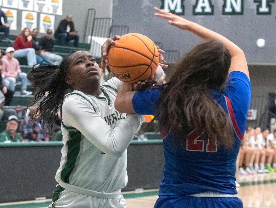 Manteca's Jada Ikharo, left, goes to the hoop against East Union's Alessandra Montes during a girls varsity basketball game at Manteca High on Jan. 11, 2024. East Union won 55-44.