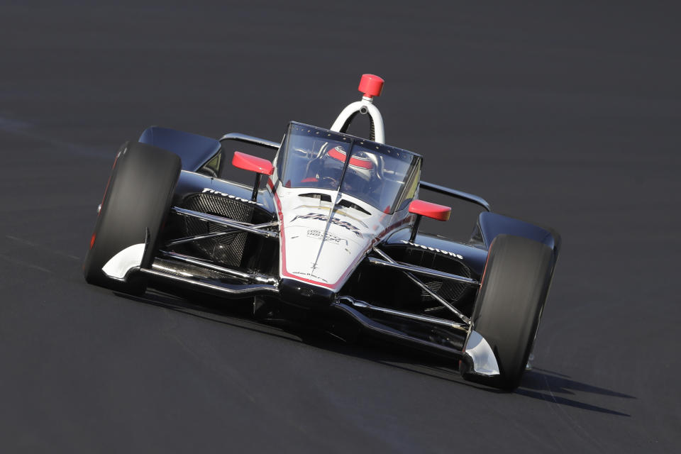 FILE - In this Oct. 2, 2019, file photo, Will Power, of Australia, drives into turn one during Aeroscreen testing at Indianapolis Motor Speedway in Indianapolis. The 2020 IndyCar season will open Saturday night, June 6, 2020, at Texas Motor Speedway. The race will also mark the official race debut of the safety innovation for enhanced driver cockpit protection. The safety feature is a ballistic, canopy-like windscreen anchored by titanium framework encompassing the cockpit. (AP Photo/Darron Cummings, File)