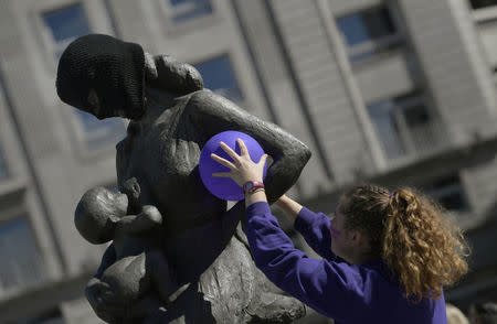 Sculptures are covered with black masks during a demonstration for women's rights on International Women's Day in the capital of the region of Asturias, in Oviedo, Spain March 8, 2018. REUTERS/Eloy Alonso.