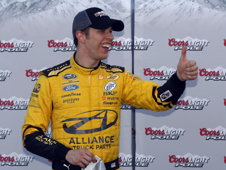 Brad Keselowski gives a thumb-up after winning the pole for Sunday's NASCAR Sprint Cup Series auto race on Friday, Feb. 28, 2014, in Avondale, Ariz. (AP Photo/Rick Scuteri)