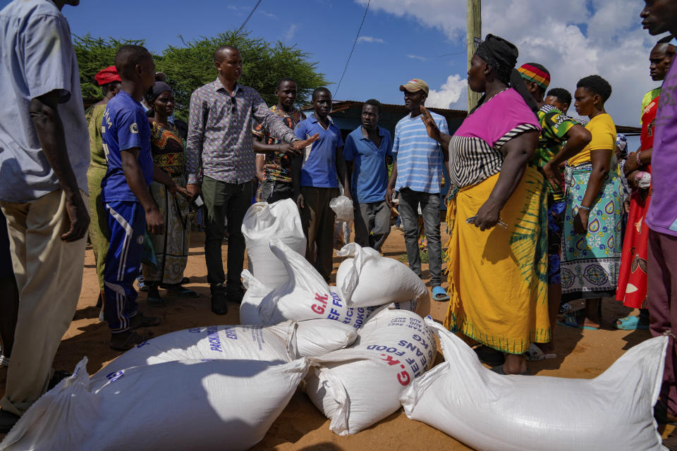 Residents gather for a planned distribution of food, after El Niño rains damaged their houses in Bangale town in Tana River county, Kenya, Sunday, Nov. 26, 2023. Severe flooding in the country has killed at least 71 people and displaced thousands, according to estimates from the UN Office for the Coordination of Humanitarian Affairs. (AP Photo/Brian Inganga).