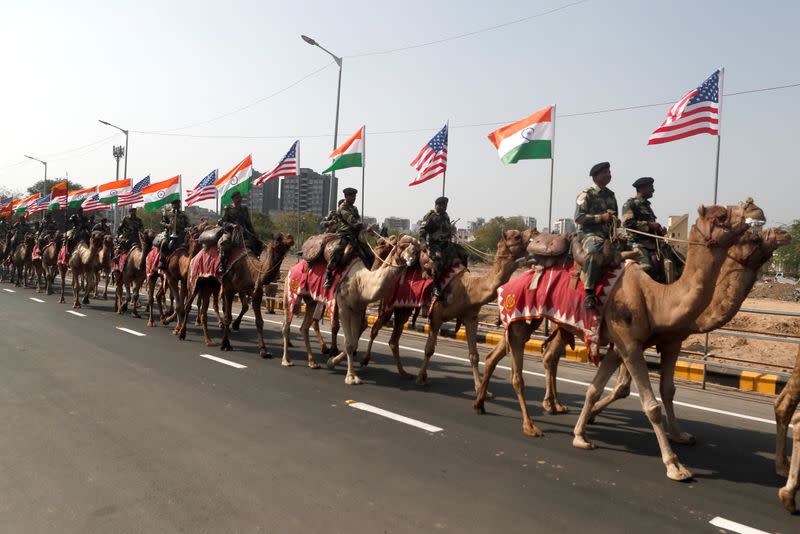 Border Security Force (BSF) soldiers ride their camels as they take part in a rehearsal for a road show ahead of the visit of U.S. President Donald Trump, in Ahmedabad