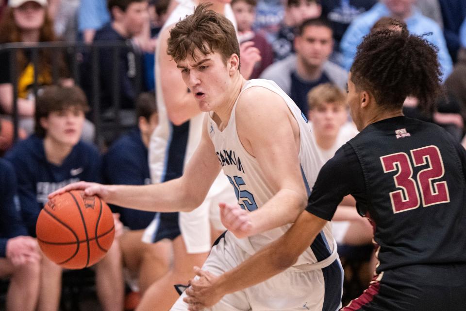 Franklin senior captain Sean O'Leary drives to the basket under pressure from BC High junior Julian Sustache during the Division 1 Elite 8 game at Franklin High, March 9, 2024. The Panthers beat the Eagles, 66-49.