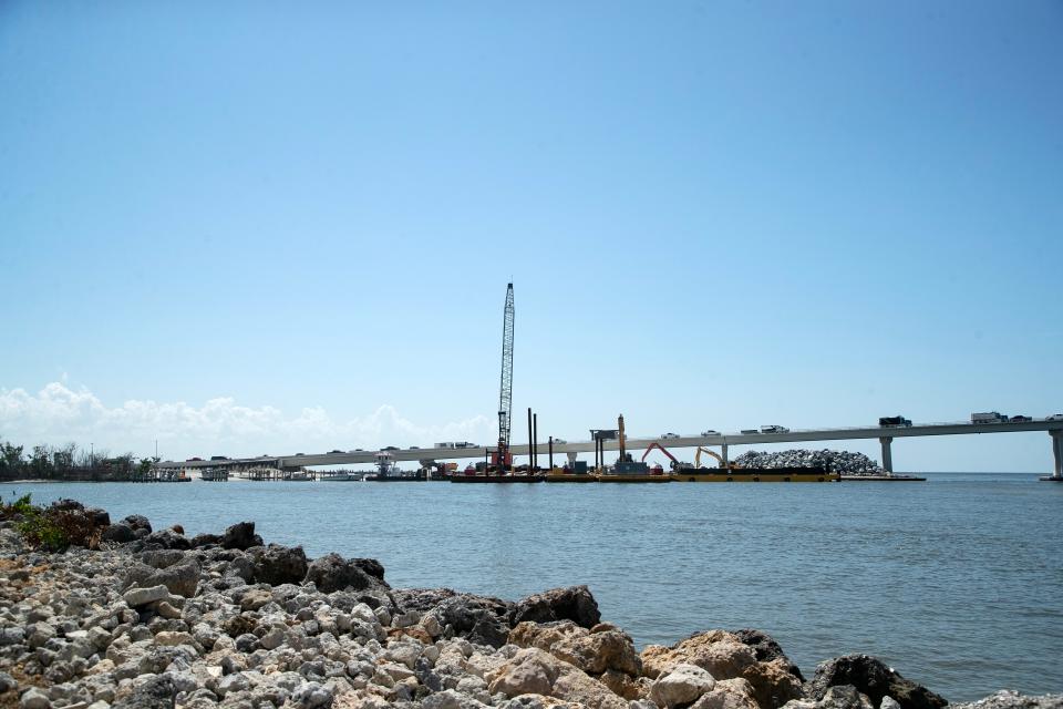 Contractors for the Florida Department of Transportation continue their work on the Sanibel Causeway on Thursday, Sept 7, 2023. Crews are paving new lanes as cranes so they can raise the existing roadway and backhoes are working in other areas to restore and improve the roadway.