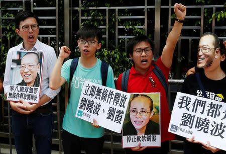Student leader Joshua Wong (2nd L) chants slogans during a protest demanding the release of Chinese Nobel rights activist Liu Xiaobo outside China's Liaison Office in Hong Kong, China June 27, 2017. REUTERS/Bobby Yip